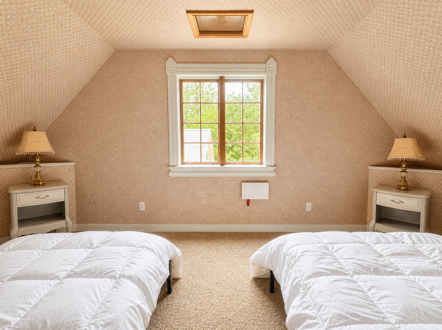 Attic bedroom with twin beds and a dormer window