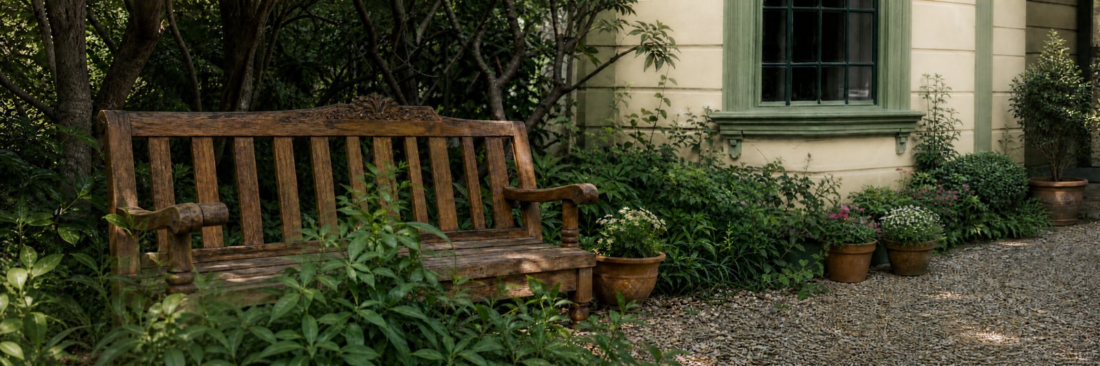 Carved wooden bench in the shaded garden beside the house